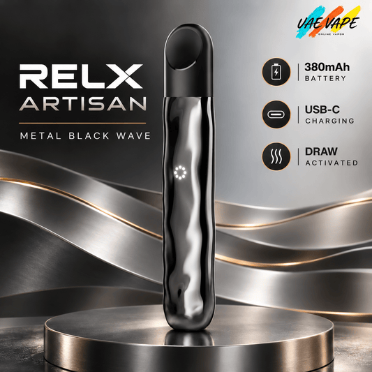 A metallic black RELX Artisan vape device stands upright on a round metallic pedestal against a dark gray.