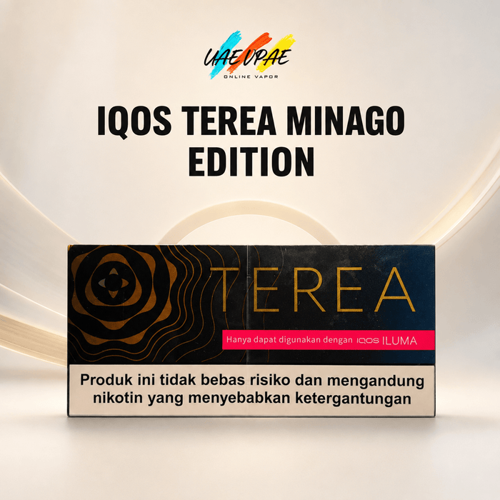 A product box for 'IQOS TEREA MINAGO EDITION' is displayed against a clean, light beige background with subtle curved lines. The box is black with gold wave patterns, gold 'TEREA' lettering, a pink banner, and a beige warning label at the bottom.